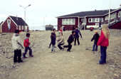 Children playing in the street in the village of Scoresbysund. E. Greenland. 2005