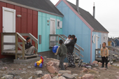 Inuit mothers and children by some housing in the centre of Scoresbysund. East Greenland. 2005