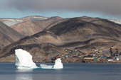 An iceberg floats by the Inuit village of Scoresbysund on the coast of Scoresbysund Fiord. East Greenland. 2005