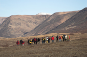 A group of tourists hiking in the Dombrava River Vallet, Hurry Inlet, Scoresbysunf Fiord. East Greenland. 2005