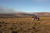 Small group of walkers on tussock tundra in the Dombrava River Vally. Hurry Inlet. East Greenland. 2005