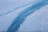Band of blue ice in an iceberg caused by meltwater getting into a fault in the ice. East Greenland. 2005