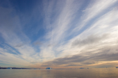 Arctic seascape with an iceberg and the Cirrus and stratus clouds. Scoresbysund Fiord, East Greenland. 2005