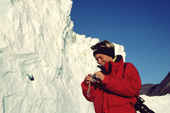 Swiss traveller checks her digital pictures of the Rolige (Calm) Glacier in Scoresbysund Fiord. East Greenland. 2005