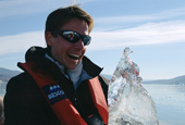 Tour guide Troels Jacobsen with a piece of crystal clear iceberg ice destined for the Bar. East Greenland. 2005