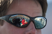 Tour Guides sunglasses reflect the zodiac he is driving and the Eielson Glacier. Rypefjord. East Greenland. 2005
