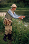 Elderly gentleman fly fishing on the River Test at Kings Sombourne. Hampshire. England