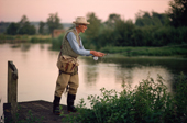 Elderly gentleman fly fishing on the River Test at Kings Sombourne. Hampshire. England