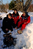 Cooking a meal over an open fire on an adventure holiday in the islands near Lulea. Sweden. 2003
