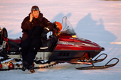 Tour guide on his mobile phone during a snowmobile trip to the islands. Lulea. Sweden. 2003