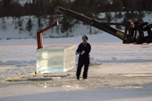 Cutting huge lumps of crystal ice from the river to build next years Ice Hotel. Jukkasjarvi. Sweden. 2003