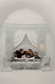 Couple toast each other in the Roman Suite, Ice Hotel. Jukkasjarvi. Sweden. 2003