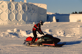 Snowmobile drives past the Ice Globe Theatre at the Ice Hotel. Jukkasjarvi. Sweden. 2003