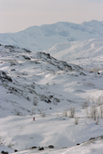 Tiny skiier crosses a valley in the mountains above Narvik. Norway. 2003