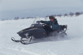 Cornering at speed on an Arctic Cat Snowmobile. Arctic Norway. 2000