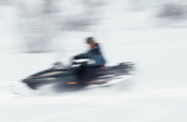 Travelling at speed on an Arctic Cat Snowmobile. Arctic Norway. 2000