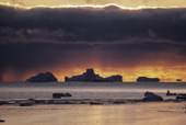 Icebergs on the horizon at sunset. Northwest Greenland. 1987