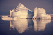 An iceberg shaped like a lemon meringue pie, bathed in warm autumn sunshine. Northwest Greenland. 1987