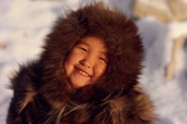 Sofie Jensen, a young Inuit girl, warmly dressed in a fox fur hooded jacket (kapataq). Qaanaaq, Northwest Greenland. (1987)