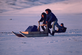 Inuit kids take the post by sled to the village store. Moriussaq, N.W.Greenland. 1987