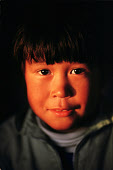Late autumn sunlight catches Qaavigarsuaq Danielsen's face,an Inuit boy from Moriussaq. Northwest Greenland. (1987)