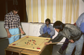 Inuit youths playing a game at a youth club. Moriussaq, Northwest Greenland. 1987
