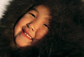 Sofie Jensen, a young Inuit girl, warmly dressed in a fox fur hooded jacket (kapataq). Qaanaaq,  Northwest Greenland. (1987)