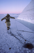 Ituko, an Inuit hunter, setting a seal net under the ice close to an iceberg near Moriussaq. Northwest Greenland. (1987)