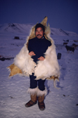 Ituko, an Inuit hunter imitates a polar bear to train his dogs. N.W. Greenland. 1987