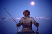Ituko, an Inuit hunter travelling by dog sled during the polar night in November near Moriussaq. Northwest Greenland. (1987)
