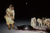 Inuit hunter, Ituko, with a seal he has caught whilst out hunting during the polar night. N.W.Greenland. 1987