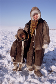 Alla Innokentivna, A Dolgan woman, with her 4 year old son Vassilly, dressed in traditional winter clothing. Taymyr, Northern Siberia, Russia. 2004