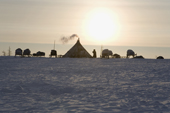 Low winter sunshine behind a Nenets reindeer herders' camp on the tundra near Salemal. Yamal, Northwest Siberia, Russia