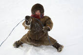 Shura Khudi, a Nenets girl, playing outside at her family's winter camp. Yamal, NW Siberia, Russia
