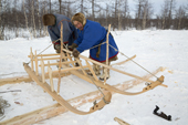 Sergey Serotetto, a Nenets reindeer herder, making a traditional sled from larch wood. Yamal, NW Siberia, Russia