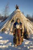 Elderly Nenets woman, Galla Serotetto, standing outside her family's tent at a reindeer herders' camp. Yamal, NW Siberia, Russia