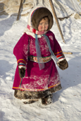 Daria Serotetto, a young Nenets girl, warmly dressed against the winter cold in traditional reindeer skin clothing. Yamal. NW Siberia, Russia