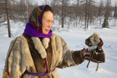 Nyaneynya Seratetto, a Nenets woman, holds an amulet figure that represents a copy of herself. It was given to her by her father to protect her after she was diagnosed with a heart condition. Yamal, NW Siberia, Russia