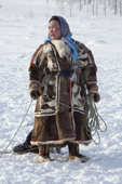 Raisa Serotetto, a Nenets woman, carrying a lasso while catching draught Reindeer near her family's winter camp. Yamal, NW Siberia, Russia