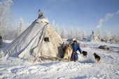 Leova Serotetto, a Nenets reindeer herder, at the entrance to his family's tent at their winter camp. Yamal, NW Siberia, Russia