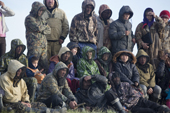 Nenets fishermen and their families listen to speeches by officials during the 'Fisherman's Holiday' celebrations on the Yuribey River. Gyda, Tazovsky region, Yamal, Siberia, Russia