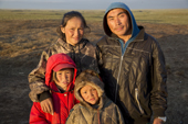 A young Nenets reindeer herding family. Daniel Yaptunay (right) and his wife, Tonia, together with their two children Alexandra & Vitally, at their summer camp on the tundra near Gyda. Tazovsky region, Yamal, Siberia, Russia