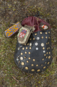 An old traditional Nenets woman's sewing bag, made of reindeer skin and decorated with metal buttons. Gyda, Tazovsky region, Yamal, Siberia, Russia