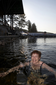 A woman swimming in winter, in freezing cold water. Jeris Ski resort, Yllas, Lapland, Finland. MR
