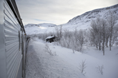 View from the Kiruna-Narvik iron ore railway in winter. Lapland, Sweden.