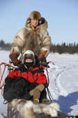Tourist enjoying a dog sled ride. Lainio, Lapland Finland. MR