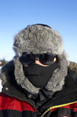 Man wearing a fur hat and protective clothing against the extreme cold. Laino, Lapland, Finland. MR