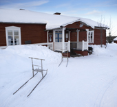 Kick sleds in front of a guest house, Lainio, Lapland, Finland.